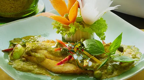 Plated Thai dish with carved vegetable garnish