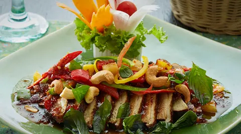 Plated Thai dish with carved vegetable garnish