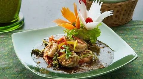 Plated Thai dish with carved vegetable garnish