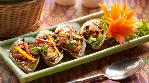 Plated Thai dish with carved vegetable garnish