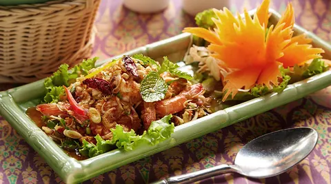 Plated Thai dish with carved vegetable garnish