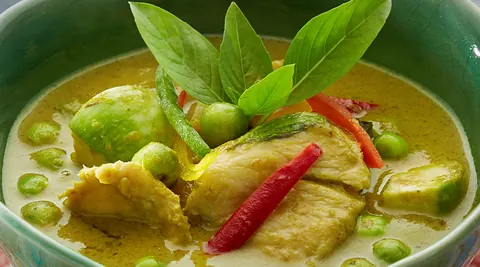Plated Thai dish with carved vegetable garnish