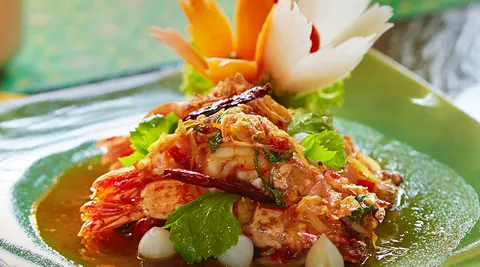 Plated Thai dish with carved vegetable garnish