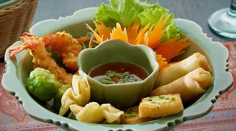 Plated Thai dish with carved vegetable garnish