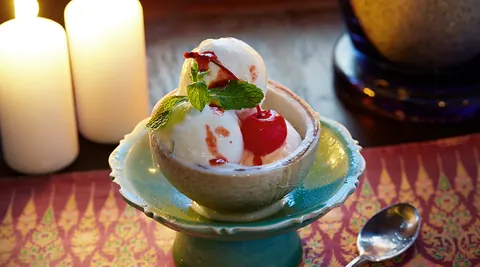 Plated Thai dish with carved vegetable garnish